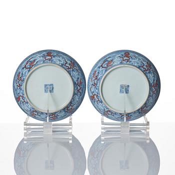 A pair of blue and white and iron red decorated dragon dishes, Qing dynasty with Daoguang mark.
