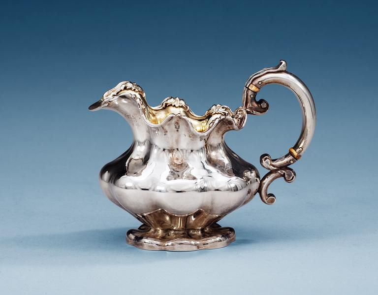 A RUSSIAN PARCEL-GILT CREAM-JUG,Makers mark of Pavel Sazikov, Moscow 19th century.
