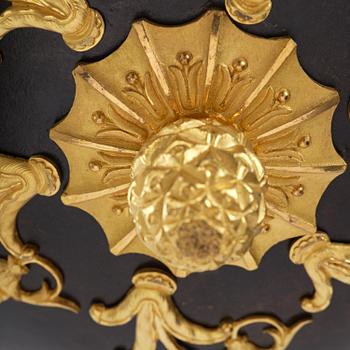 A patinated and ormolu six-light Empire chandelier, Stockholm, first part 19th century.
