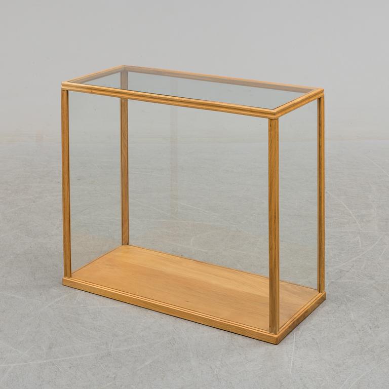 a mid 20th century oak and glass cabinet.