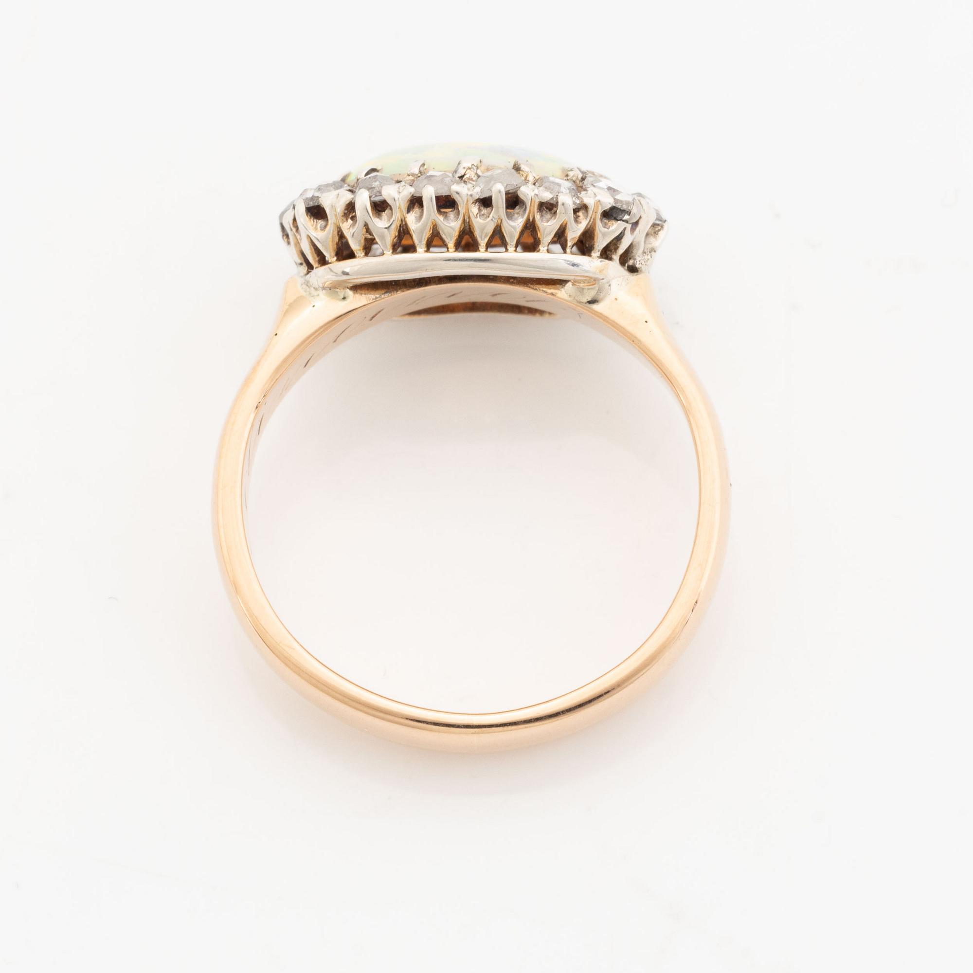 An 18K gold and opal ring set with rose-cut diamonds.