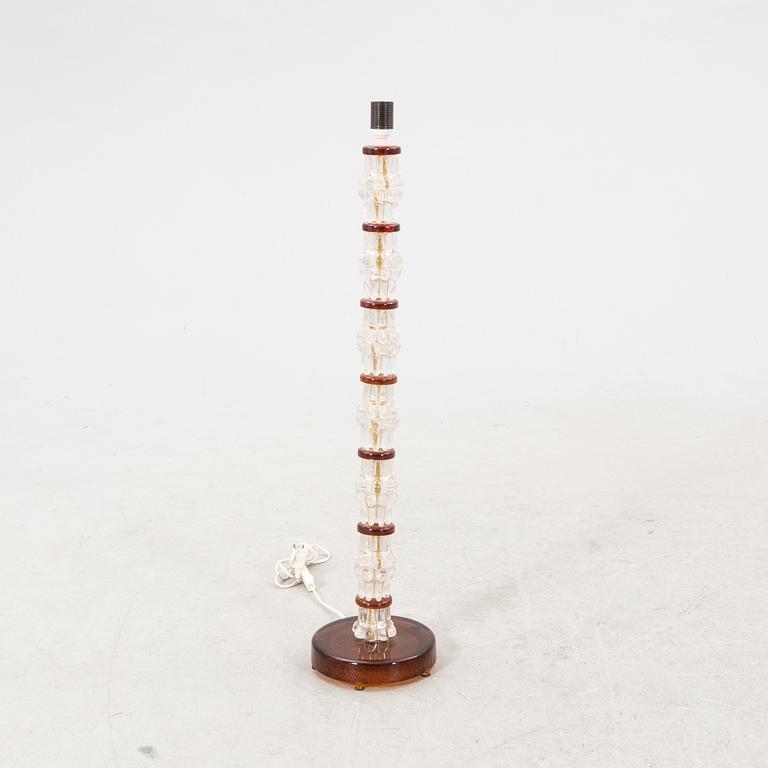 A 1970s glass floor lamp.