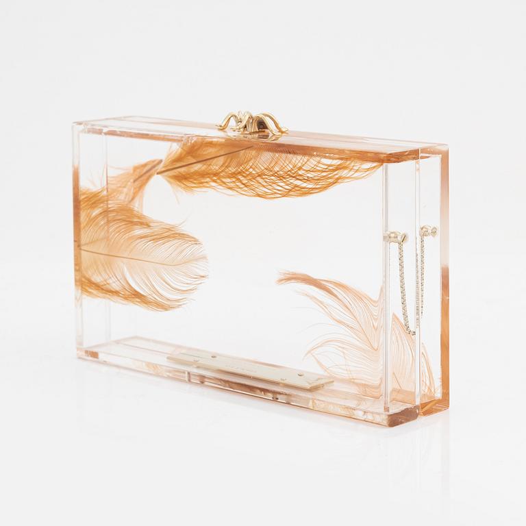 Charlotte Olympia, a transparent clutch with feathers and a spider.