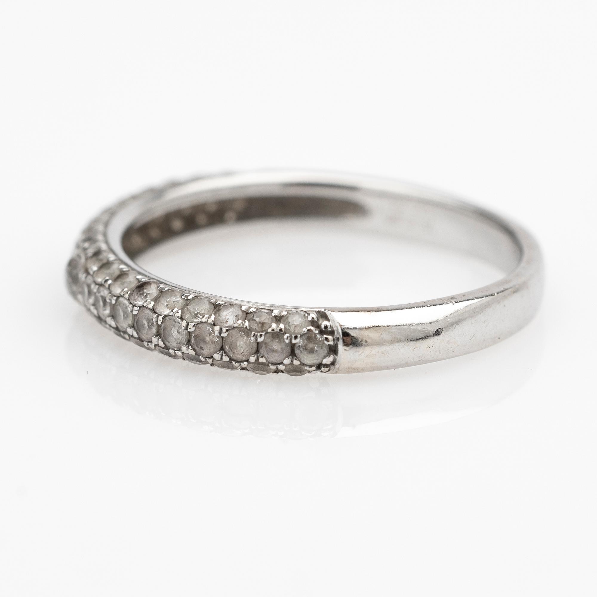 Ring, 14k white gold with brilliant-cut diamond and white stones.