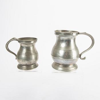 A set of five pewter tankards and six bowls England 20th century.