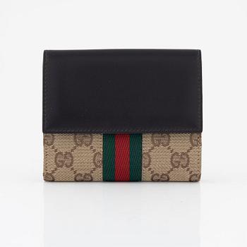 Gucci, a leather and canvas wallet, 1999.