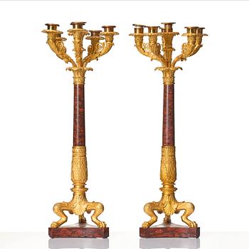 A pair of French Empire ormolu and rouge griotte six-branch candelabra, first part of the 18th century.