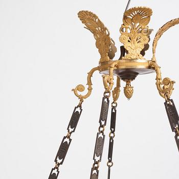 An Empire.style five-branch patinated and gilt bronze chandelier, later part of the 19th century.