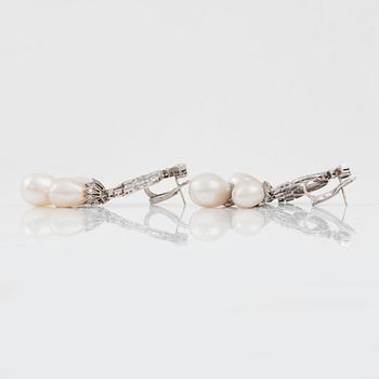 A pair of natural drop-shaped saltwater pearl and diamond Girandole earrings.
