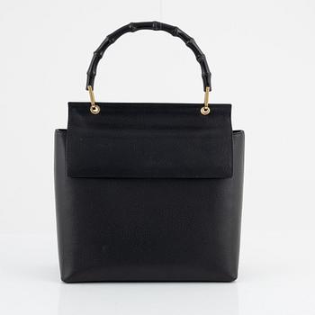 Gucci, a black leather and bamboo bag.