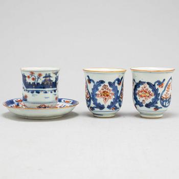 A pair of imari cups and a cup and saucer, Qing dynasty, 18th century.