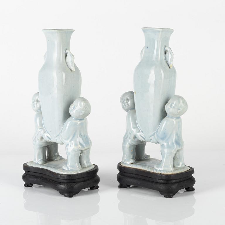 A pair of Chinese pale blue boys vases, around 1900.