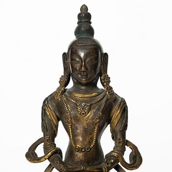 A gilt copper figure of Amitayus, Tibeto-Chinese, 18th Century.