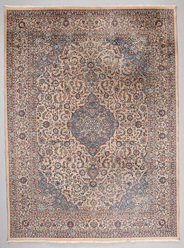 A carpet from Mashad, around 381 x 297 cm.