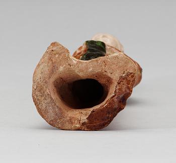 A green and yellow glazed figure of a standing lady, Tang dynasty.