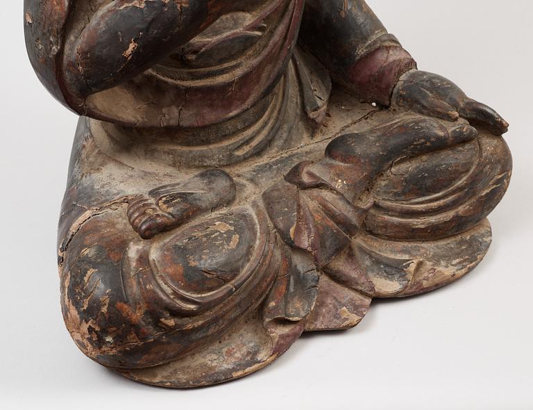 A Japanese partly lacquered wooden seated figure of Buddha, Edo (1603-1868).