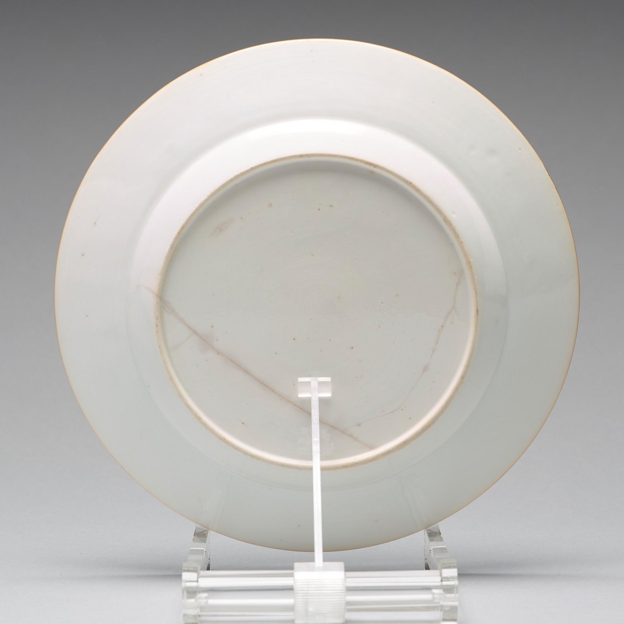 A set of four blue and white armorial dinner plates, Qing dynasty, 18th Century.