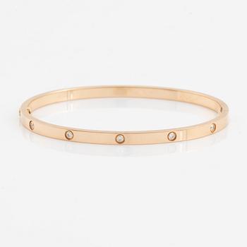 A Cartier "Love" bracelet small model in 18K rose gold with ten round brilliant-cut diamonds.