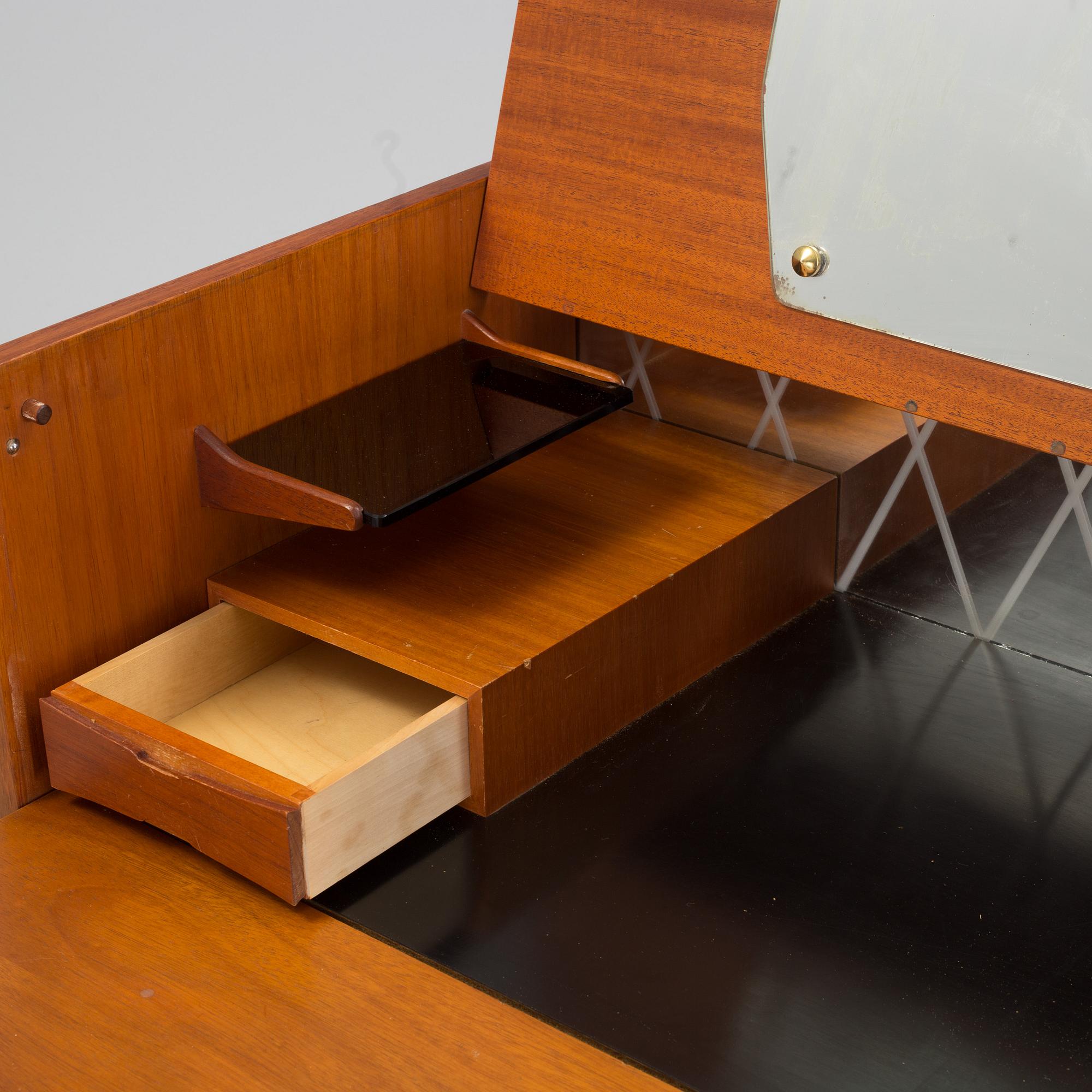 A mid 20th century teak dressing commode.