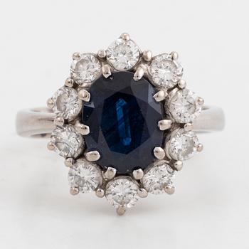 Sapphire and brilliant-cut diamond cluster ring.