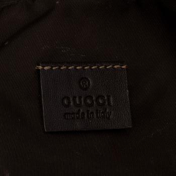 GUCCI, a monogram beauty bag.