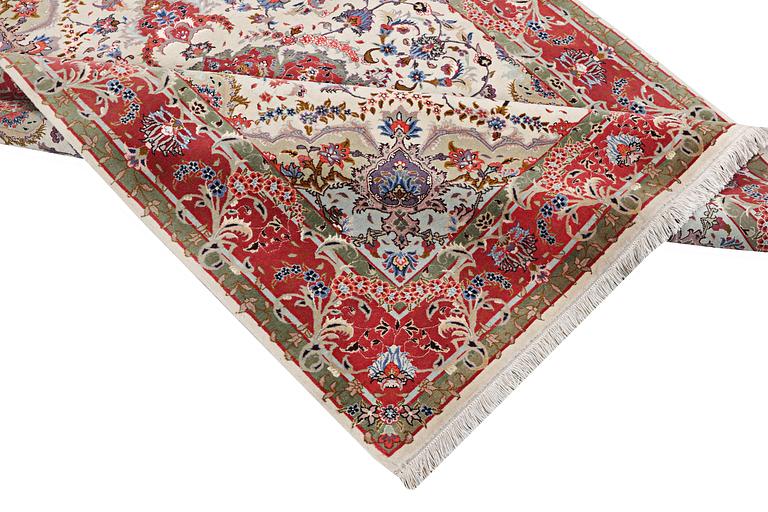 A Tabriz rug, part silk, 50 raj, c. 204 x 154 cm.