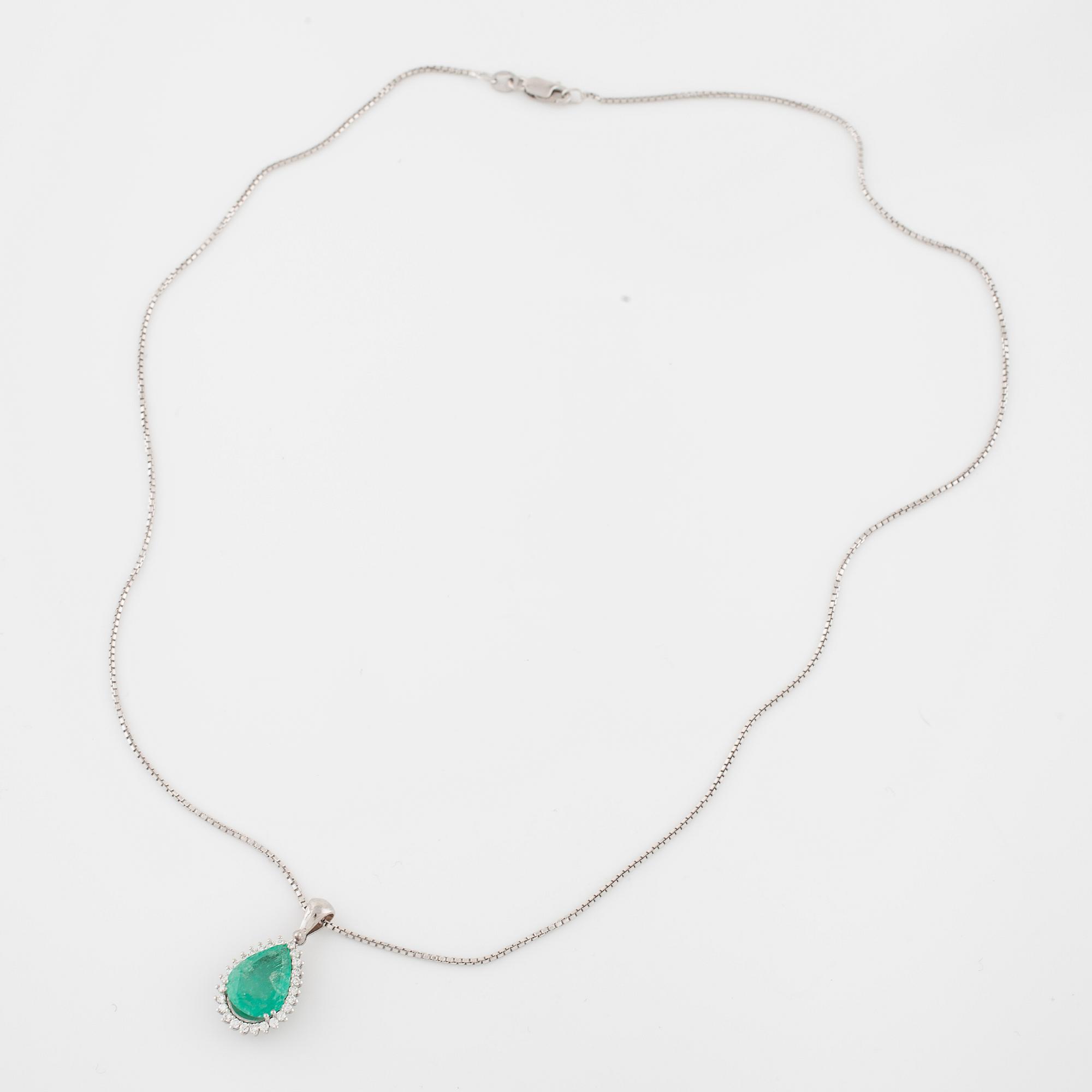 An emerald and brilliant cut diamond pendant.