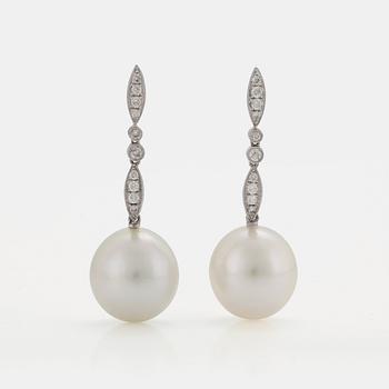 A PAIR OF EARRINGS set with cultured South Sea pearls and round brilliant-cut diamonds.