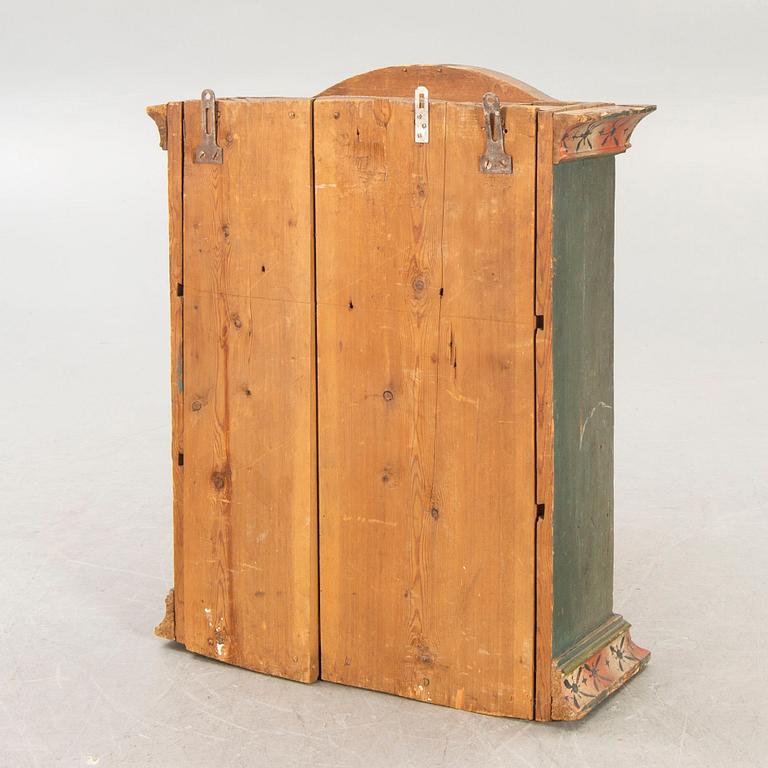A painted Swedish wall cabinet dated 1808.