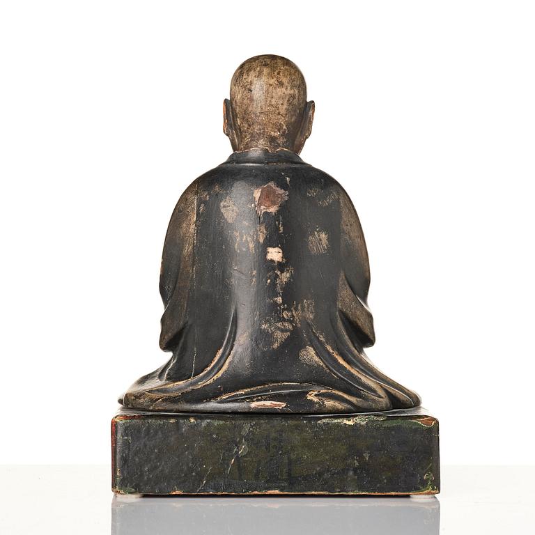 A painted and lacquered wooden sculpture of a monk, Japan, 19th century.