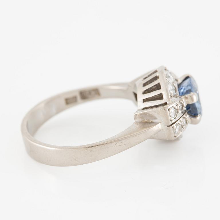 Ring 18K white gold set with a faceted sapphire and round brilliant-cut diamonds.