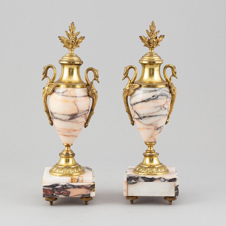 A pair of gilt brass and quartzite decorative urns, circa 1900.