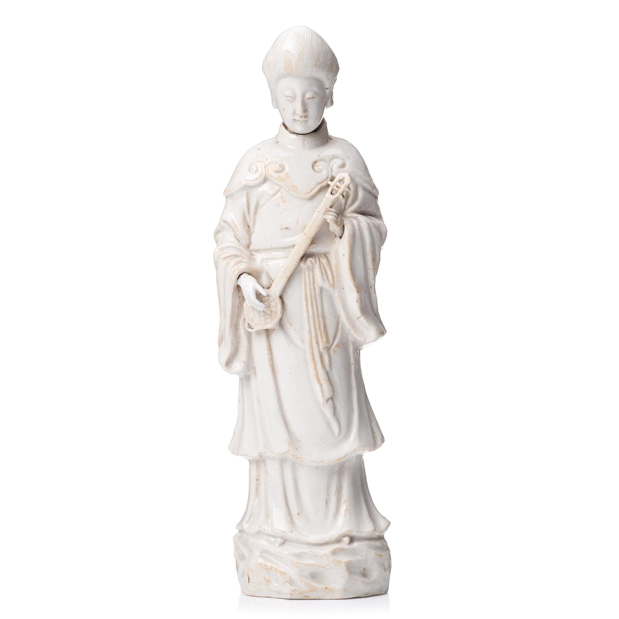 A blanc de chine figure of a lady-in-waiting, Qing dynasty, Kangxi (1662-1722).