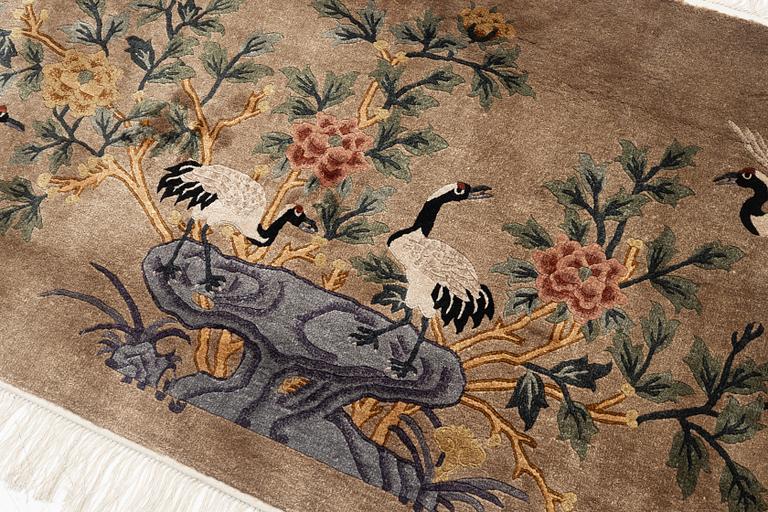 A silke figural rug, China, later part of the 20th century, ca. 92 x 170 cm.