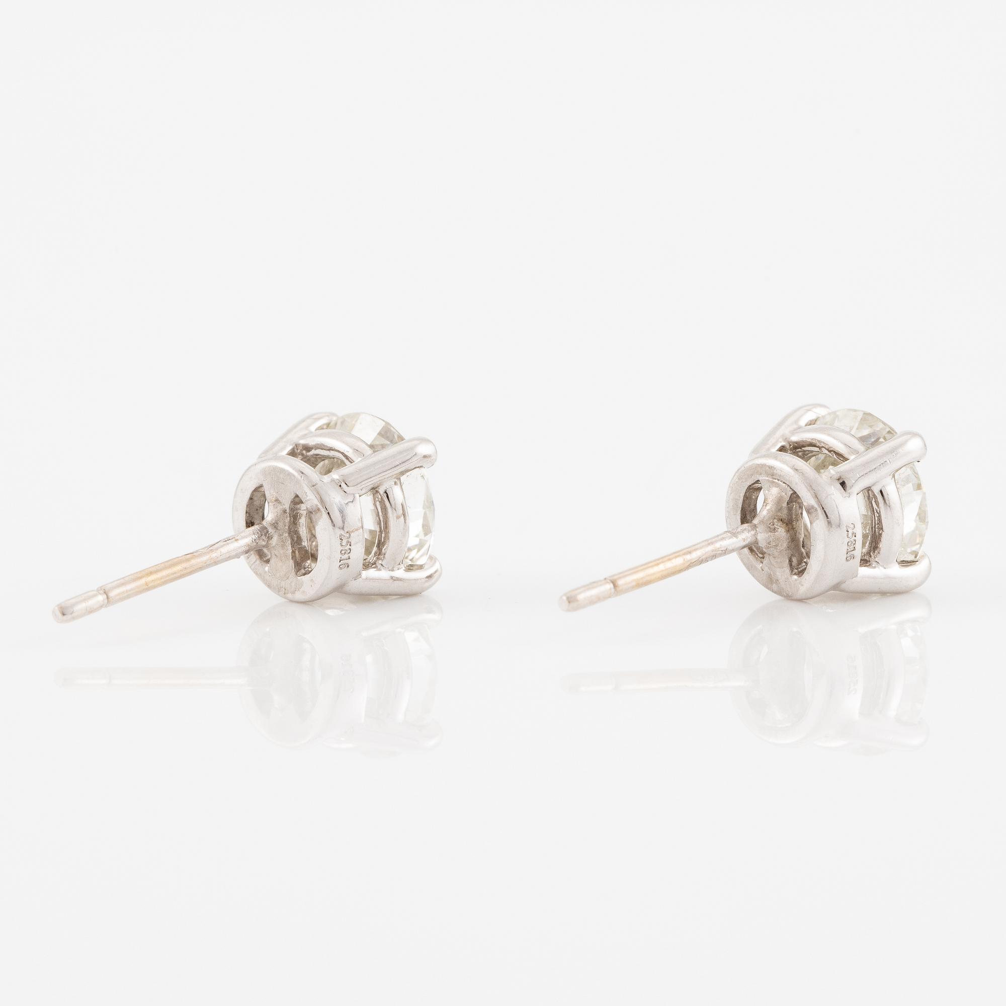 A pair of earrings in 18K white gold set with two round brilliant-cut diamonds, likely Tiffany & Co.