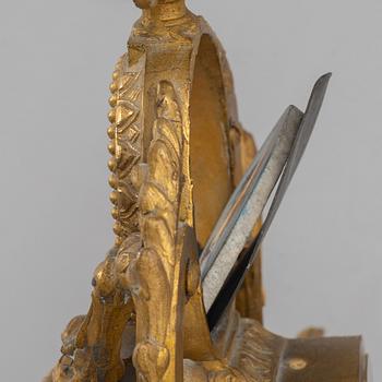 A Louis XVI style mantel clock and a pair of candelabra, circa 1900.