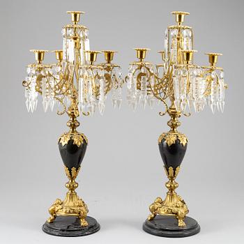 A pair of Oscarian candelabra in stone and brass.