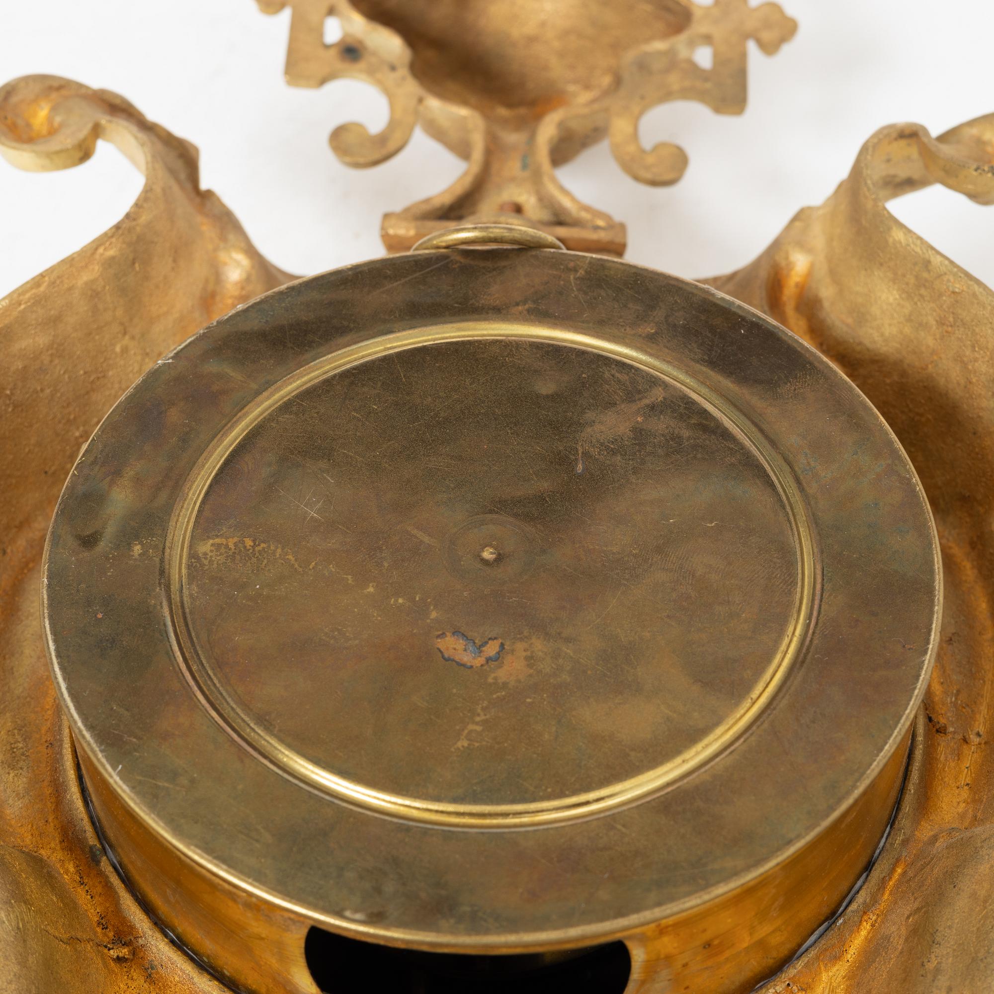 A bronze wall clock, Louis XVI style, France, circa 1900.