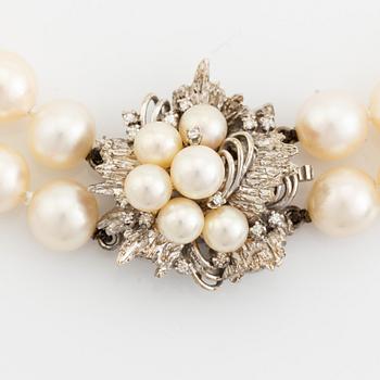 Cultured pearl necklace, clasp 14K white gold with pearl and eight cut diamonds.