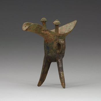 A bronze ritural tripod wine vessel 'Jue', presumably Shang dynasty, 12/11th Century BC.