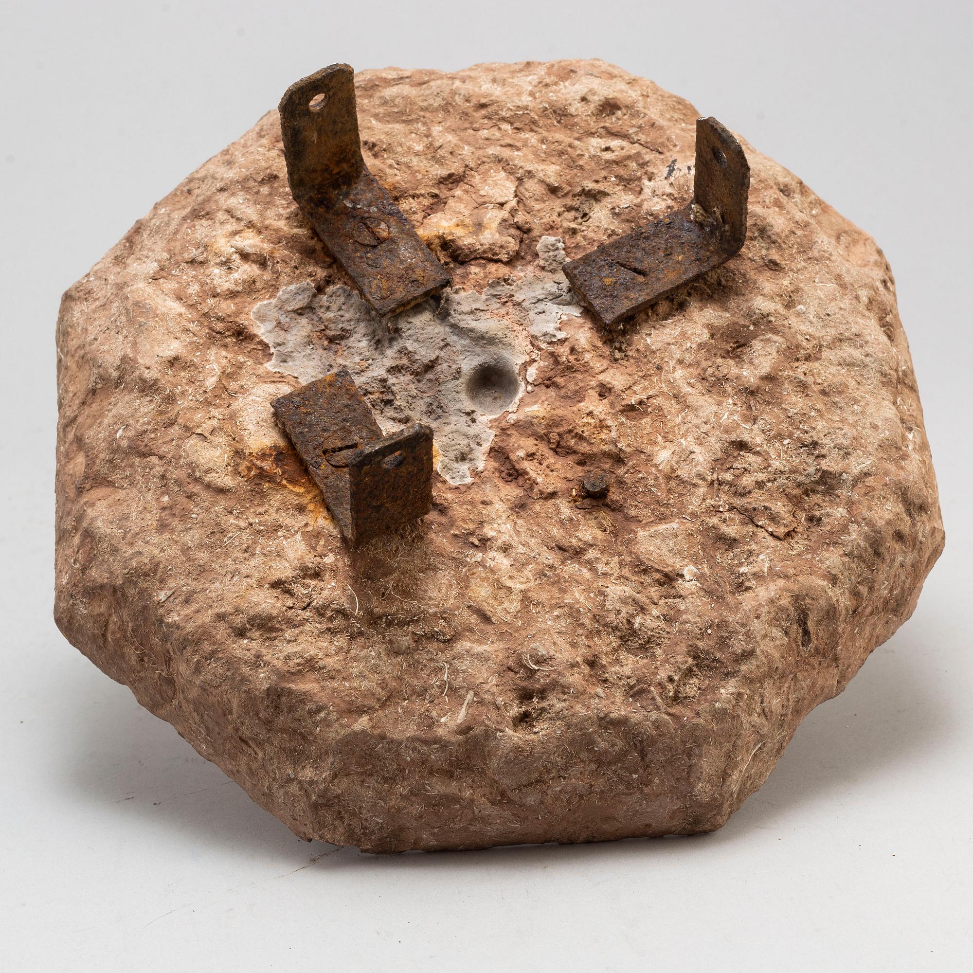A limestone and iron sundial dated 1732.