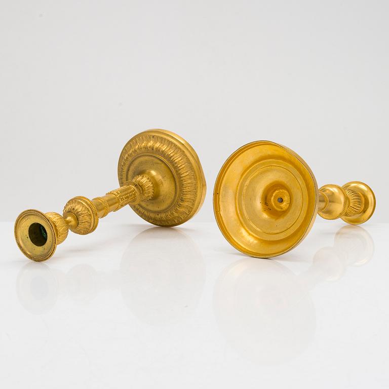 A pair of mid-19th-century gilded bronze candlesticks.