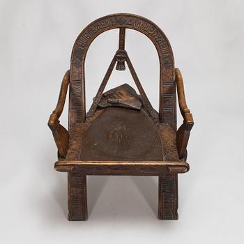 A carved oak wood armchair after V.P. Shutov's design "Arch, axe and gloves", Russia, late 19th century.