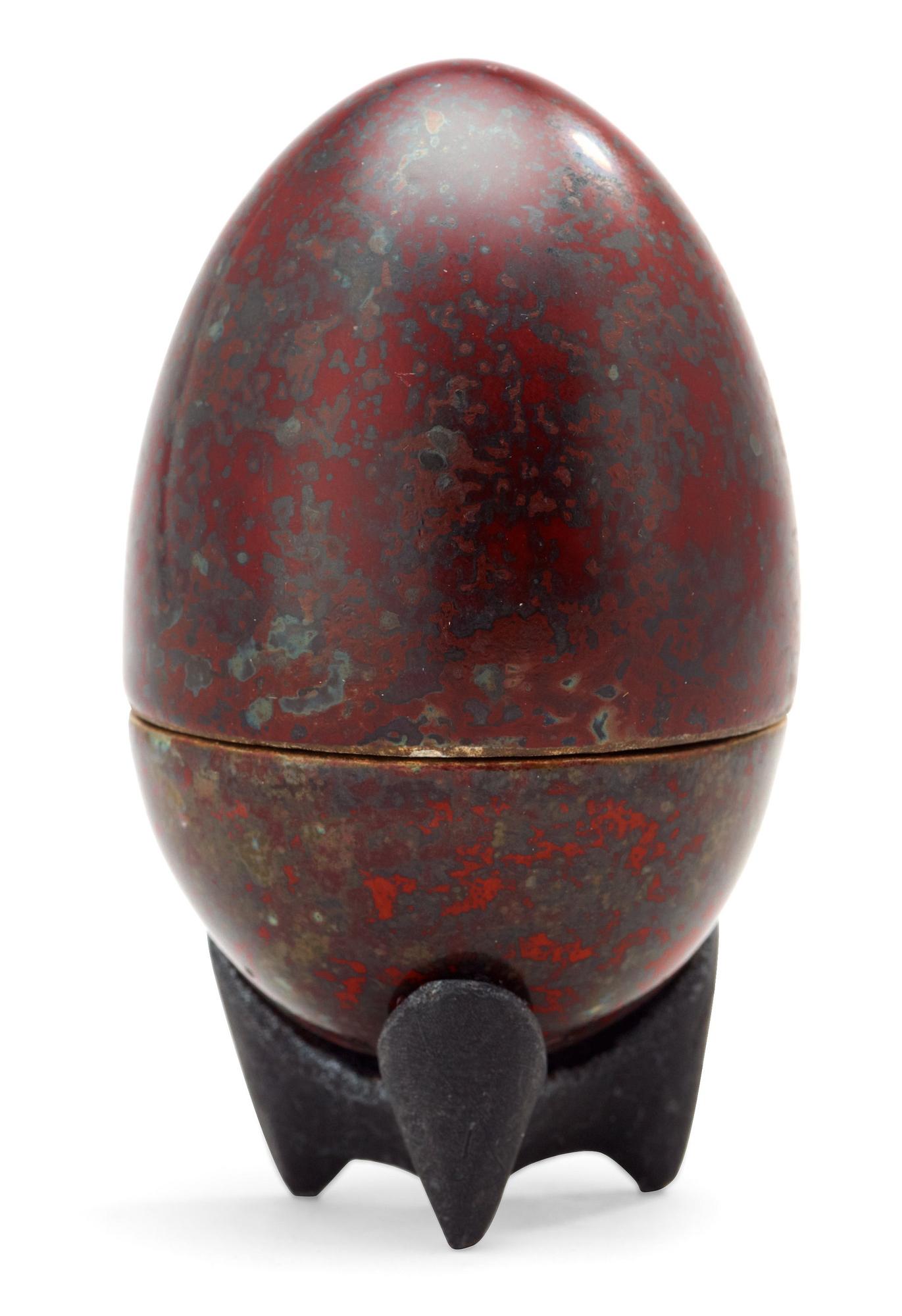 A Hans Hedberg faience egg on an iron base, Biot, France.