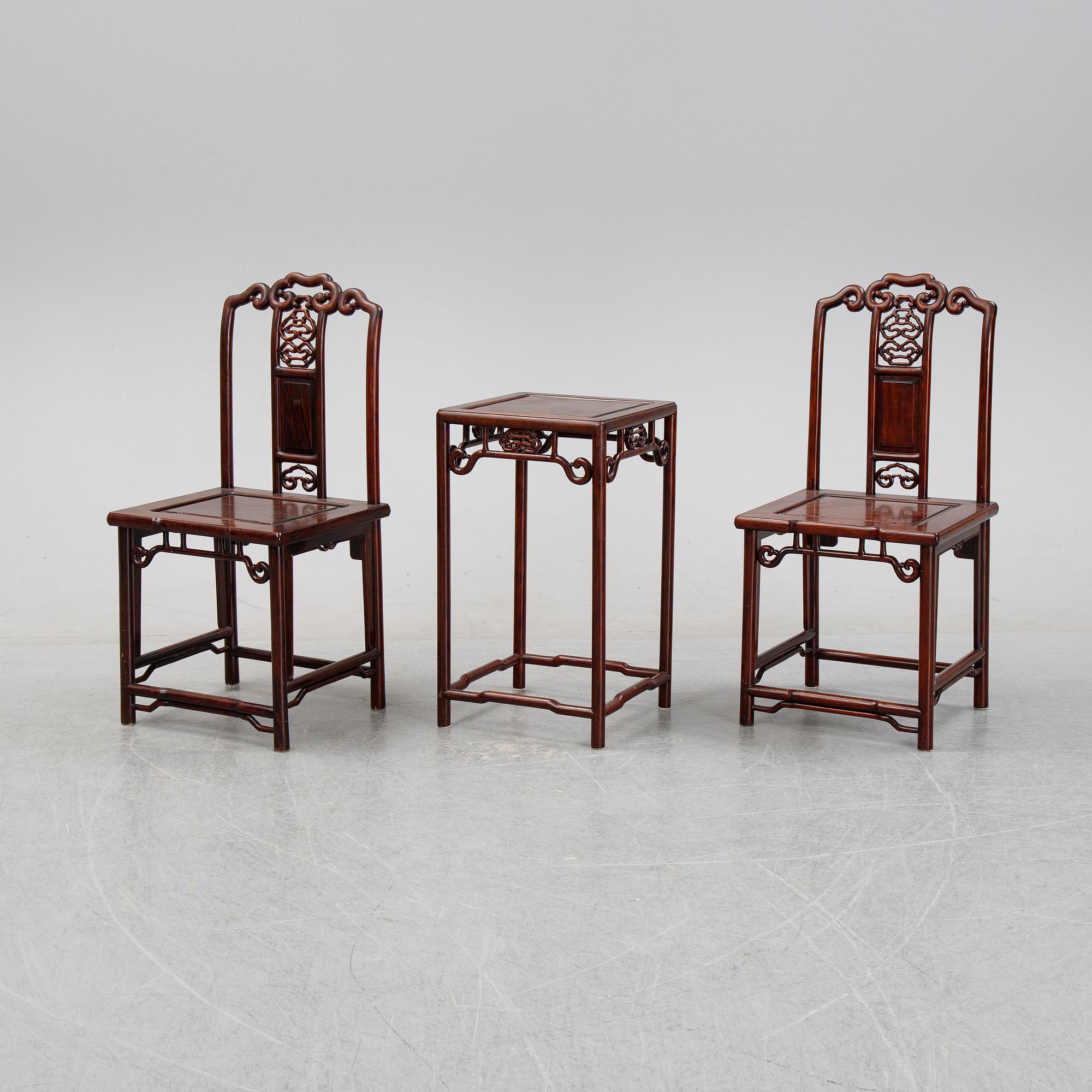 A pair of Chinese hardwood contemporary chairs and table.