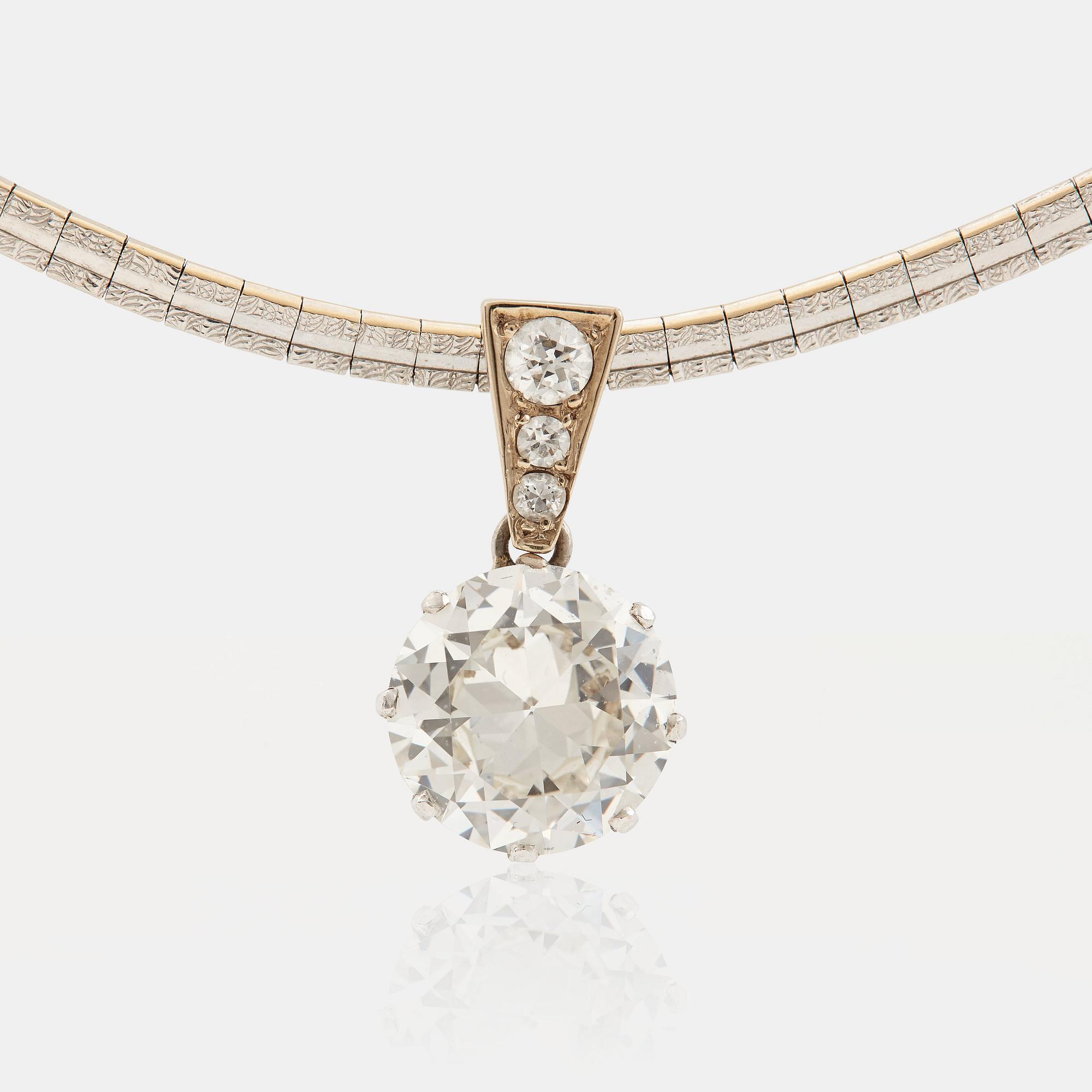 A platinum and 14K white gold pendant set with an old-cut diamond weight ca 3.00 cts quality ca K/L vs.