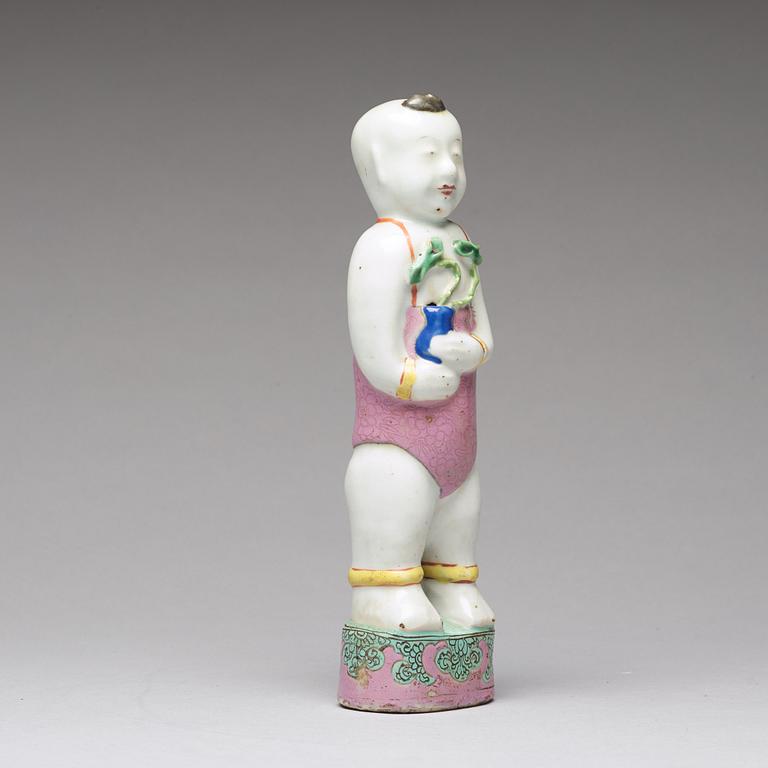 A famille rose porcelain figure of a laughing boy, Qing dynasty, 18th Century.