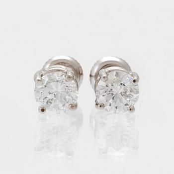 A pair of 14K white gold earrings set with round brilliant-cut diamonds.