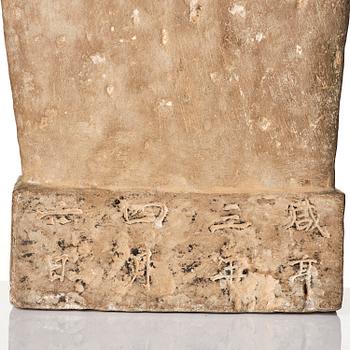 An inscribed limestone Buddhist stele, Tang style, with an inscription the third year of the Xian, corresponding to 672.