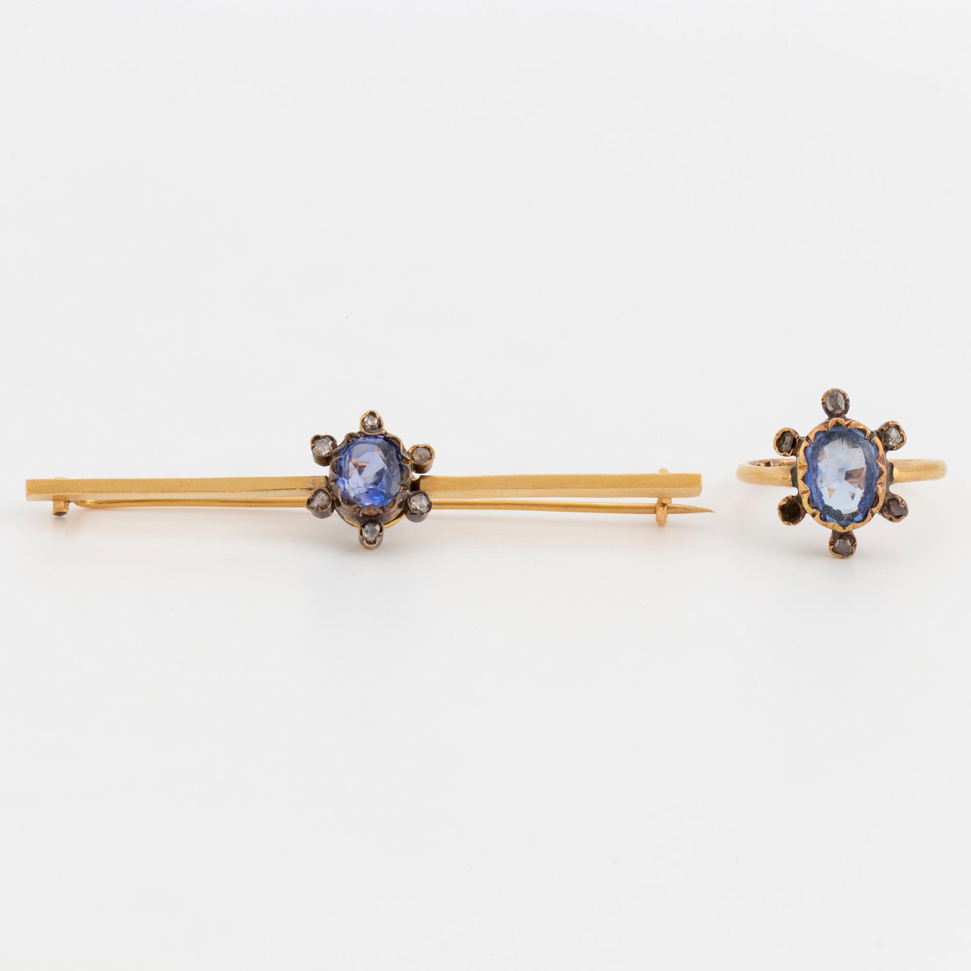An 18K gold brooch and ring set with oval, mixed-cut sapphires and rose-cut diamonds.